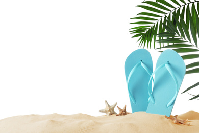 Light blue flip flops and starfishes on sand against white background. Beach objects