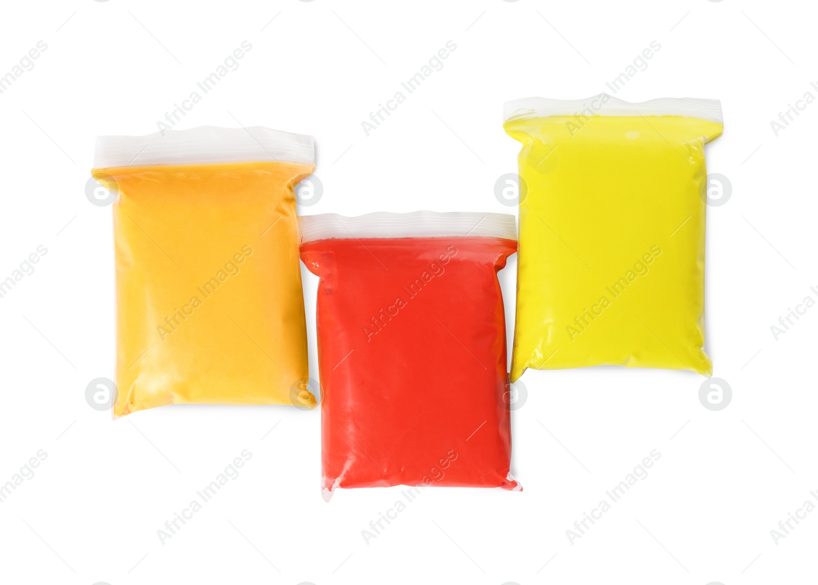 Photo of Packages of colorful play dough on white background, top view