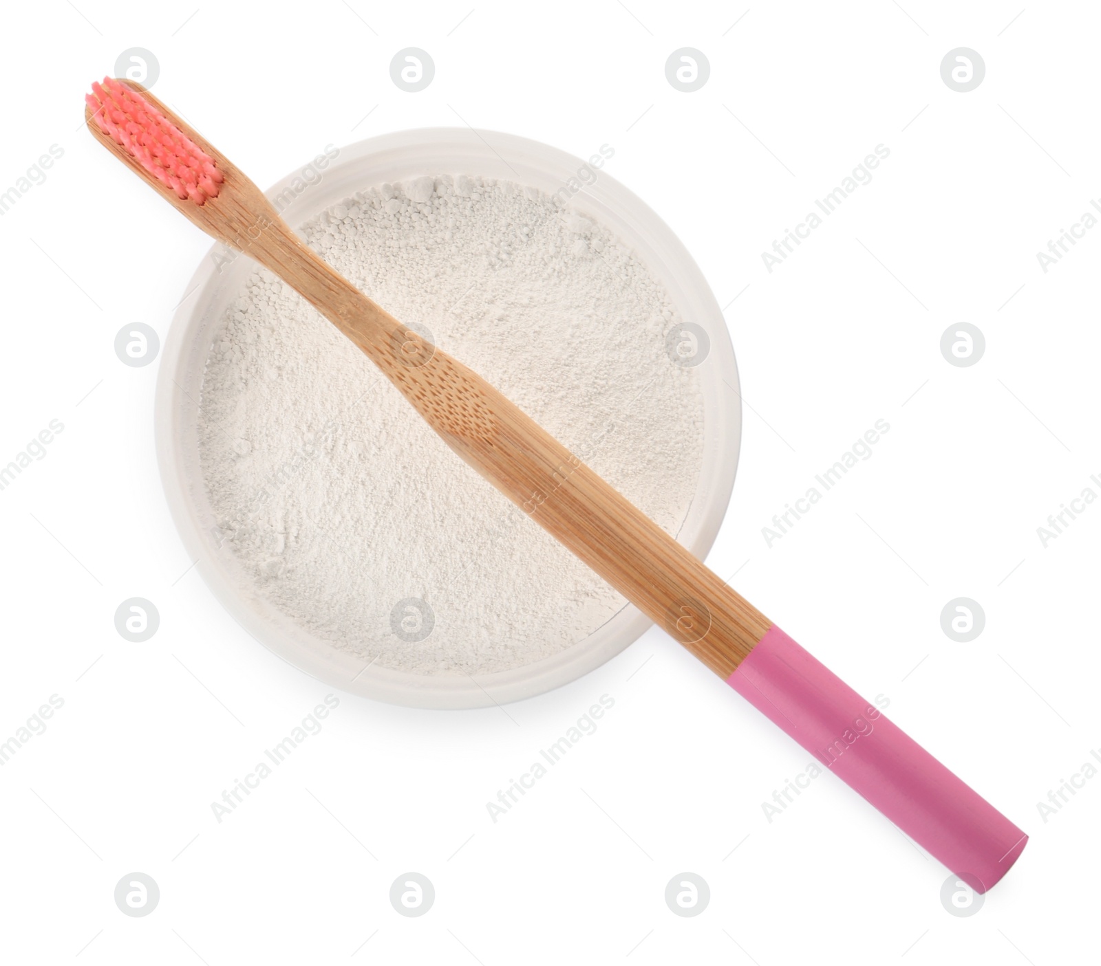 Photo of Bowl of tooth powder and brush on white background, top view