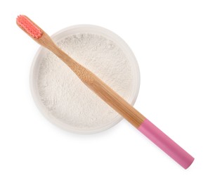 Bowl of tooth powder and brush on white background, top view