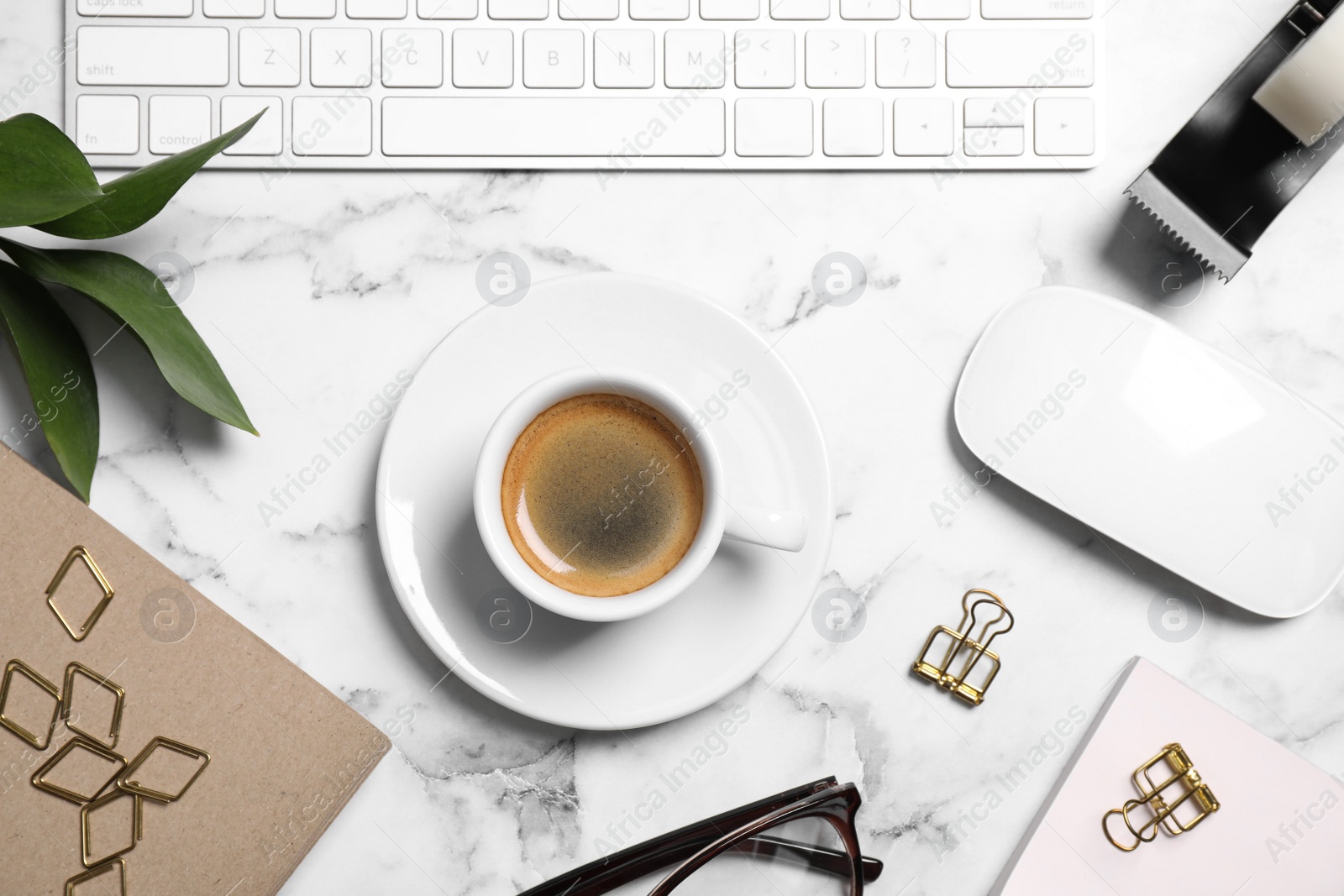 Photo of Flat lay composition with cup of coffee and computer keyboard on white marble table