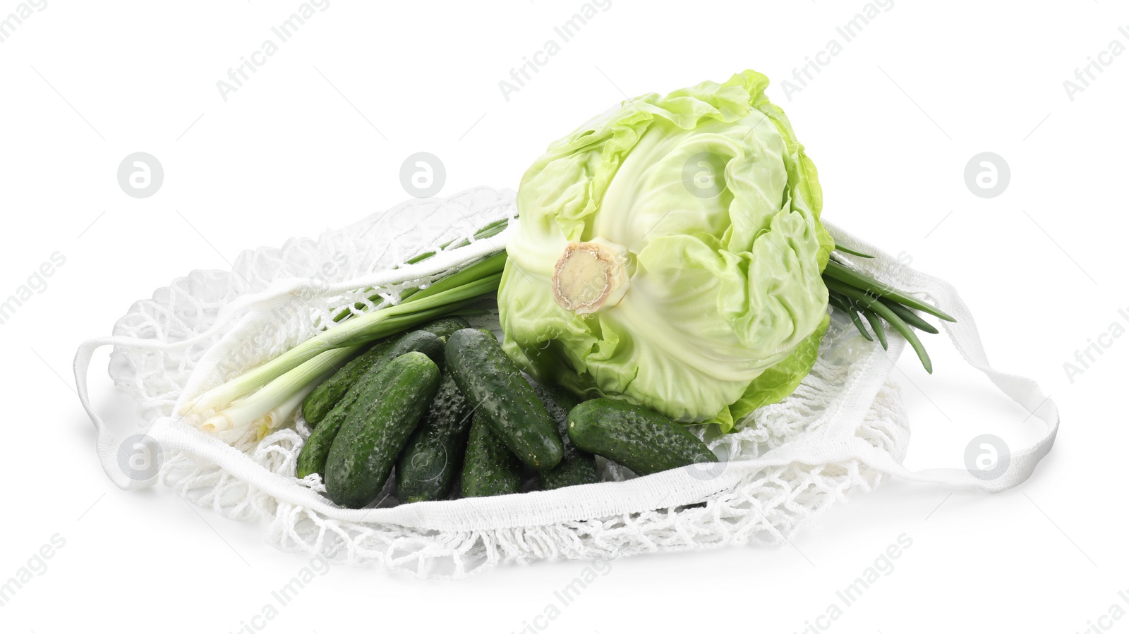 Photo of String bag with different vegetables isolated on white