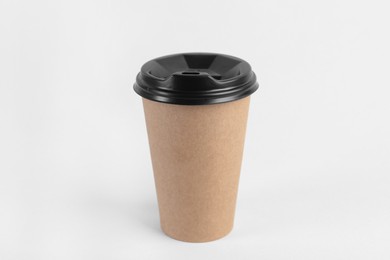 Photo of Paper cup with plastic lid on light background. Coffee to go