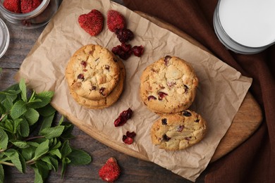 Photo of Cookies with freeze dried fruits and mint on wooden table, flat lay