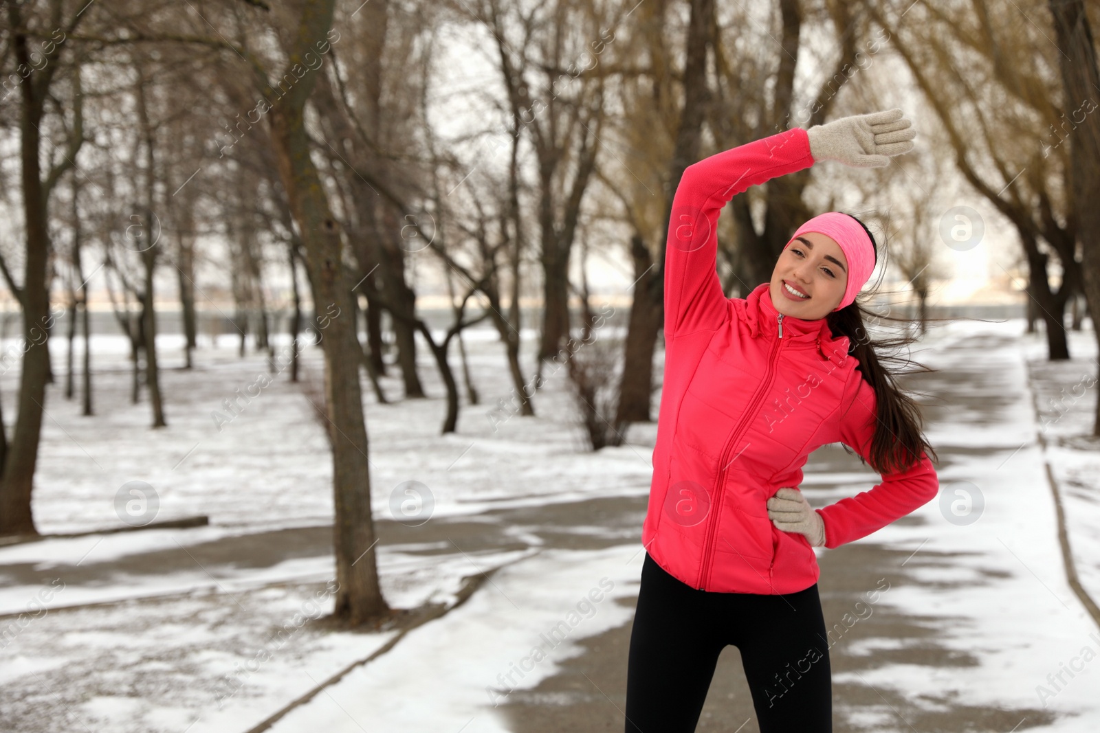 Photo of Woman doing sports exercises in winter park