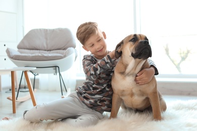 Cute little child with his dog at home