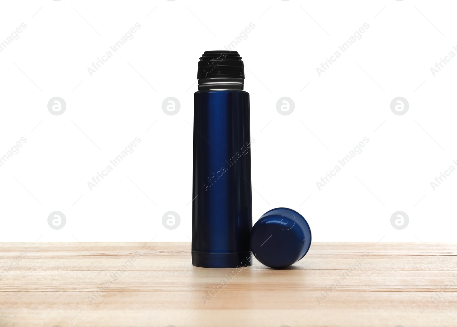 Photo of Stylish thermo bottle on wooden table against white background