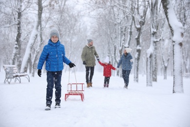 Family spending time outside on winter day. Christmas vacation