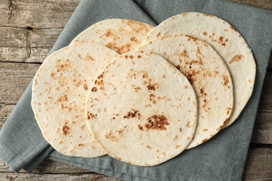 Tasty homemade tortillas on wooden table, top view