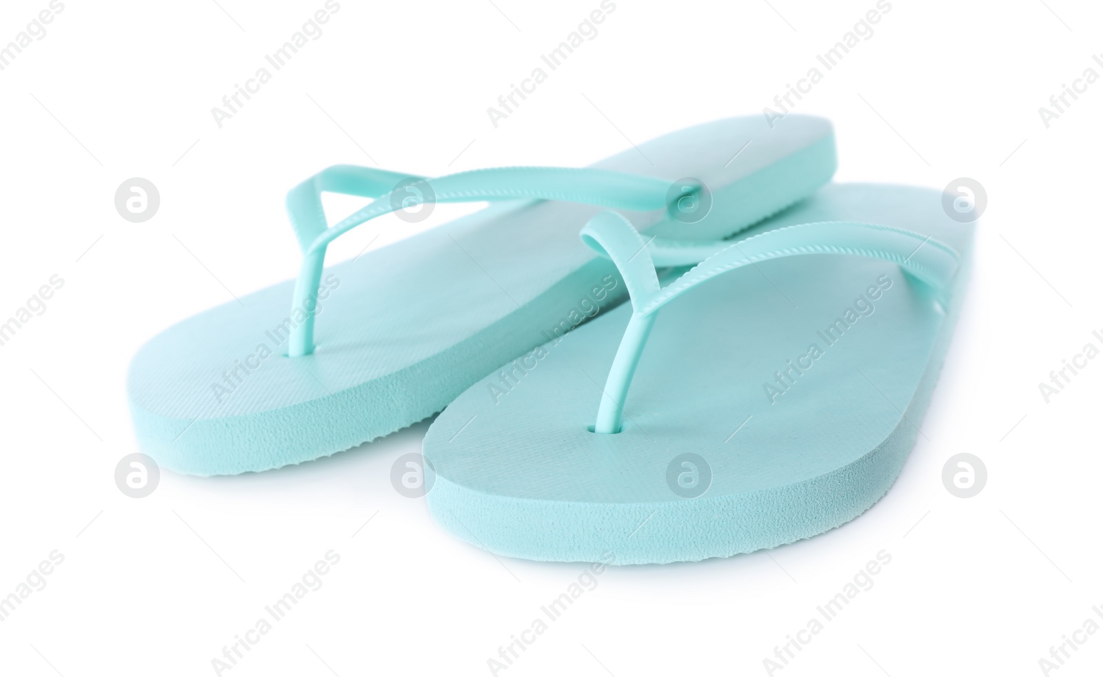 Photo of Light blue flip flops isolated on white. Beach accessory