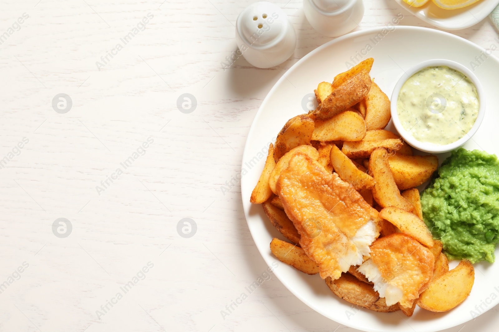 Photo of British Traditional Fish and potato chips on wooden background, flat lay. Space for text