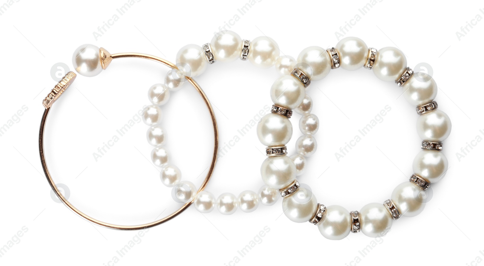 Photo of Different elegant bracelets with pearls on white background, top view