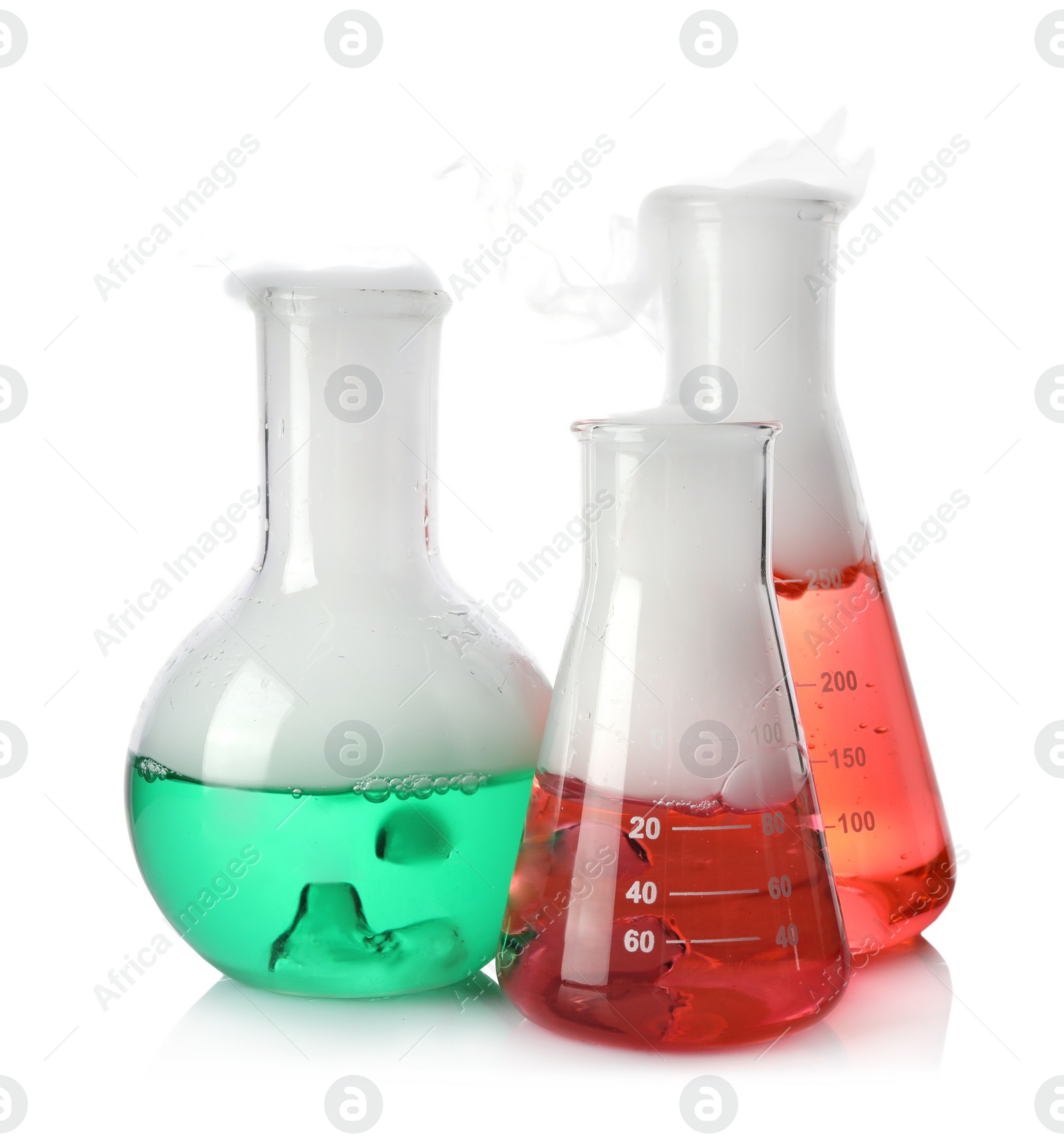 Photo of Laboratory flasks with colorful liquids and steam isolated on white. Chemical reaction