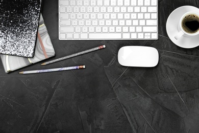 Photo of Flat lay composition with computer keyboard and notebooks on grey background, space for text. Graphic designer's workplace