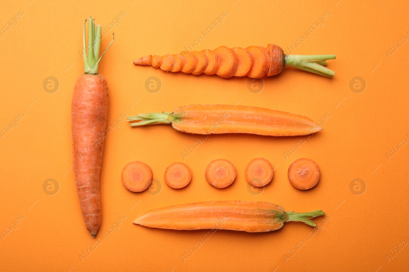 Photo of Flat lay composition with fresh carrots on color background