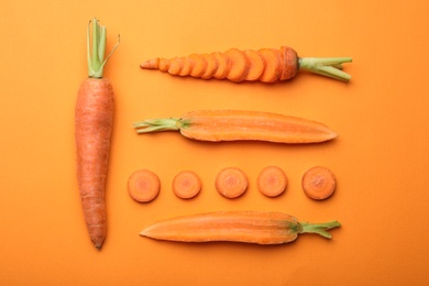 Photo of Flat lay composition with fresh carrots on color background