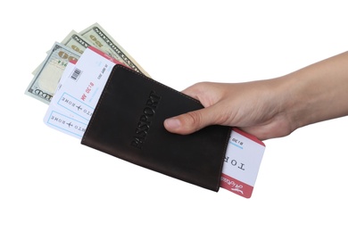 Photo of Woman holding passport with money and tickets on white background, closeup. Travel agency concept