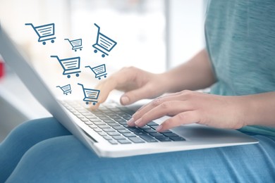 Image of Woman using laptop for online shopping at home, closeup