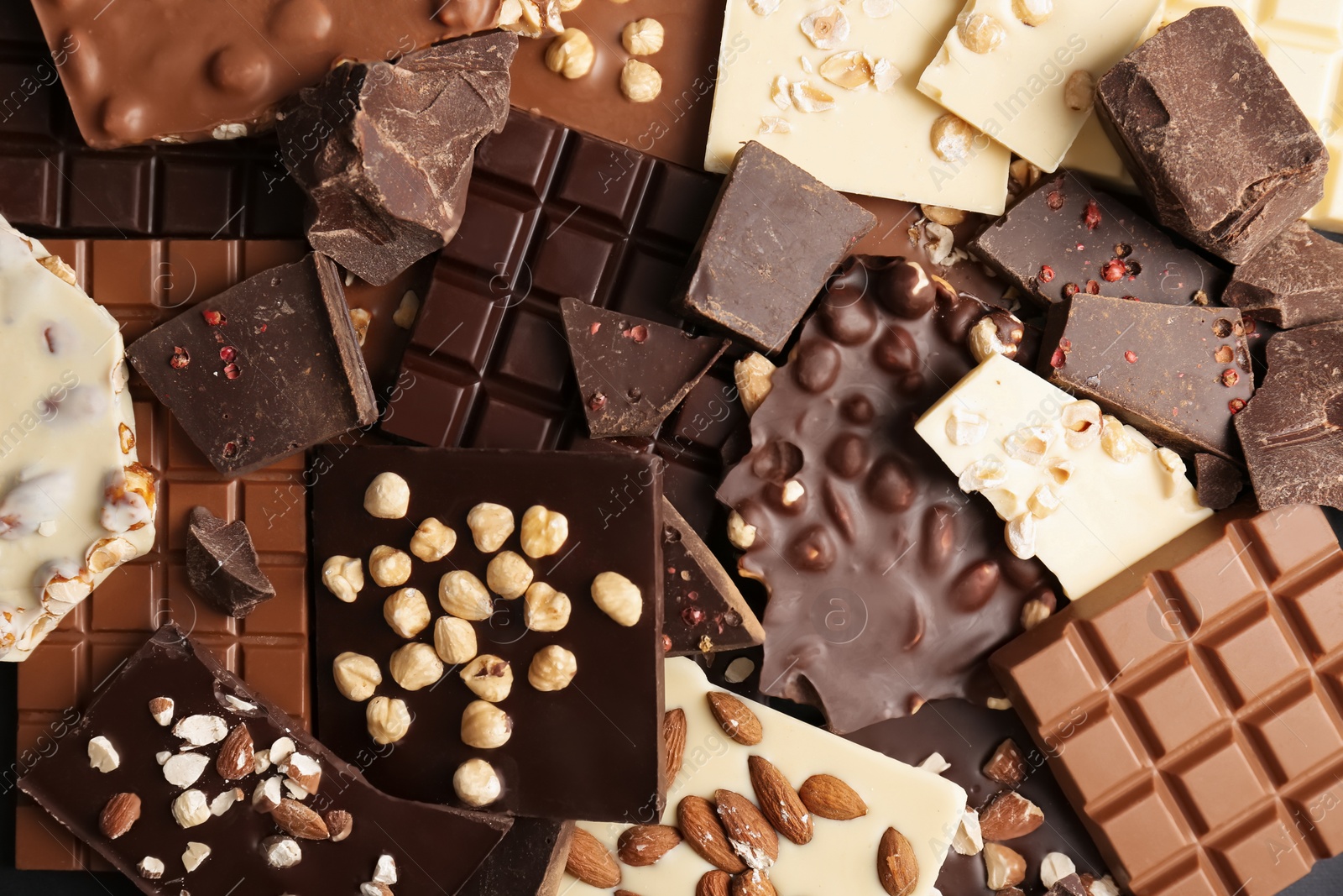 Photo of Many different delicious chocolate bars as background