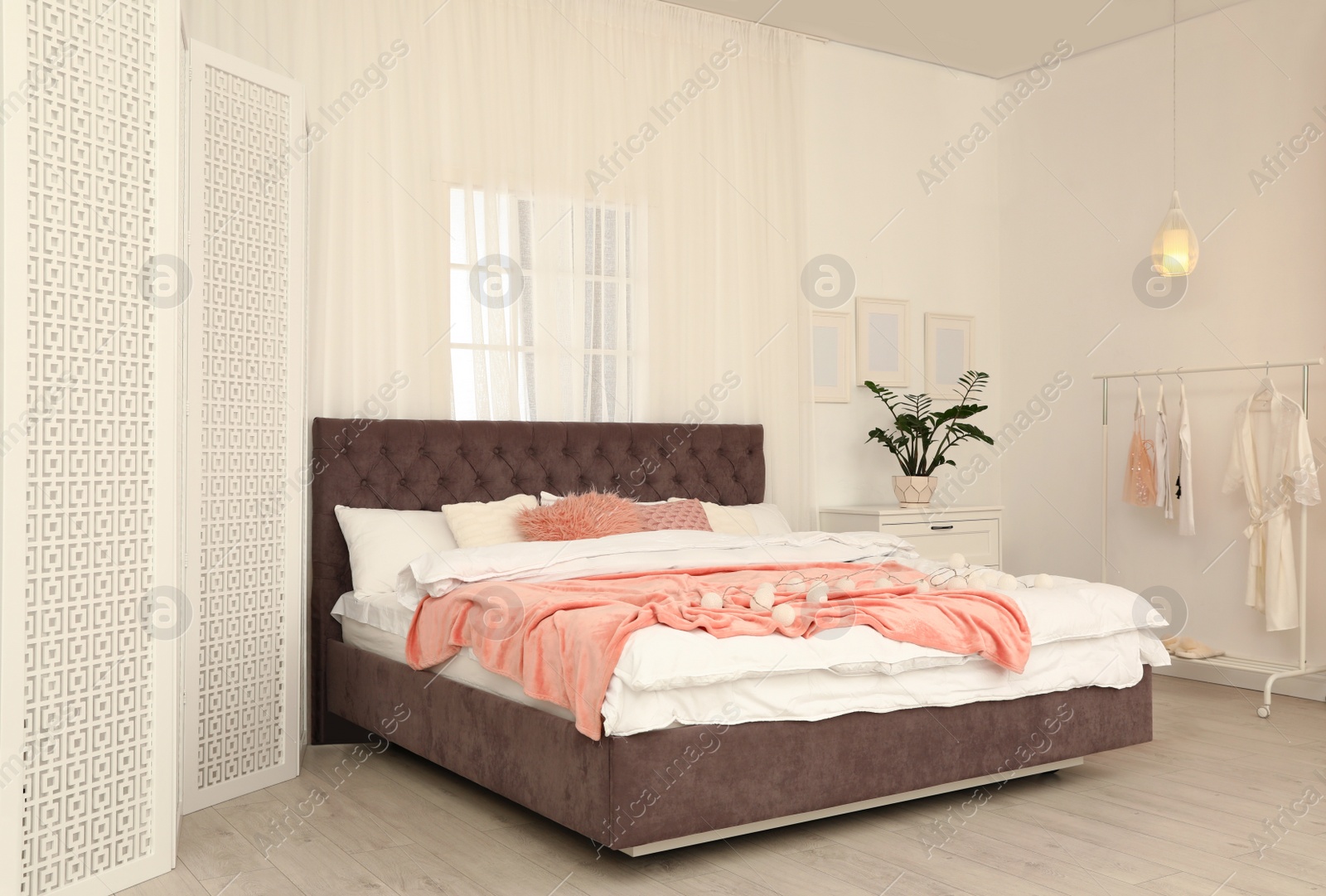 Photo of Modern folding screen in stylish bedroom interior