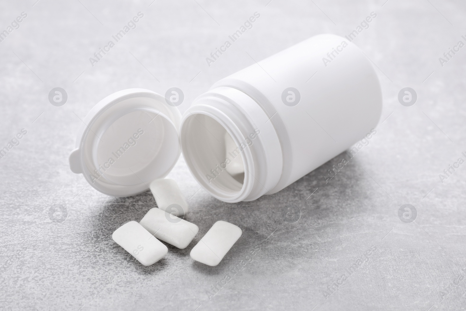 Photo of Jar with chewing gums on light grey table