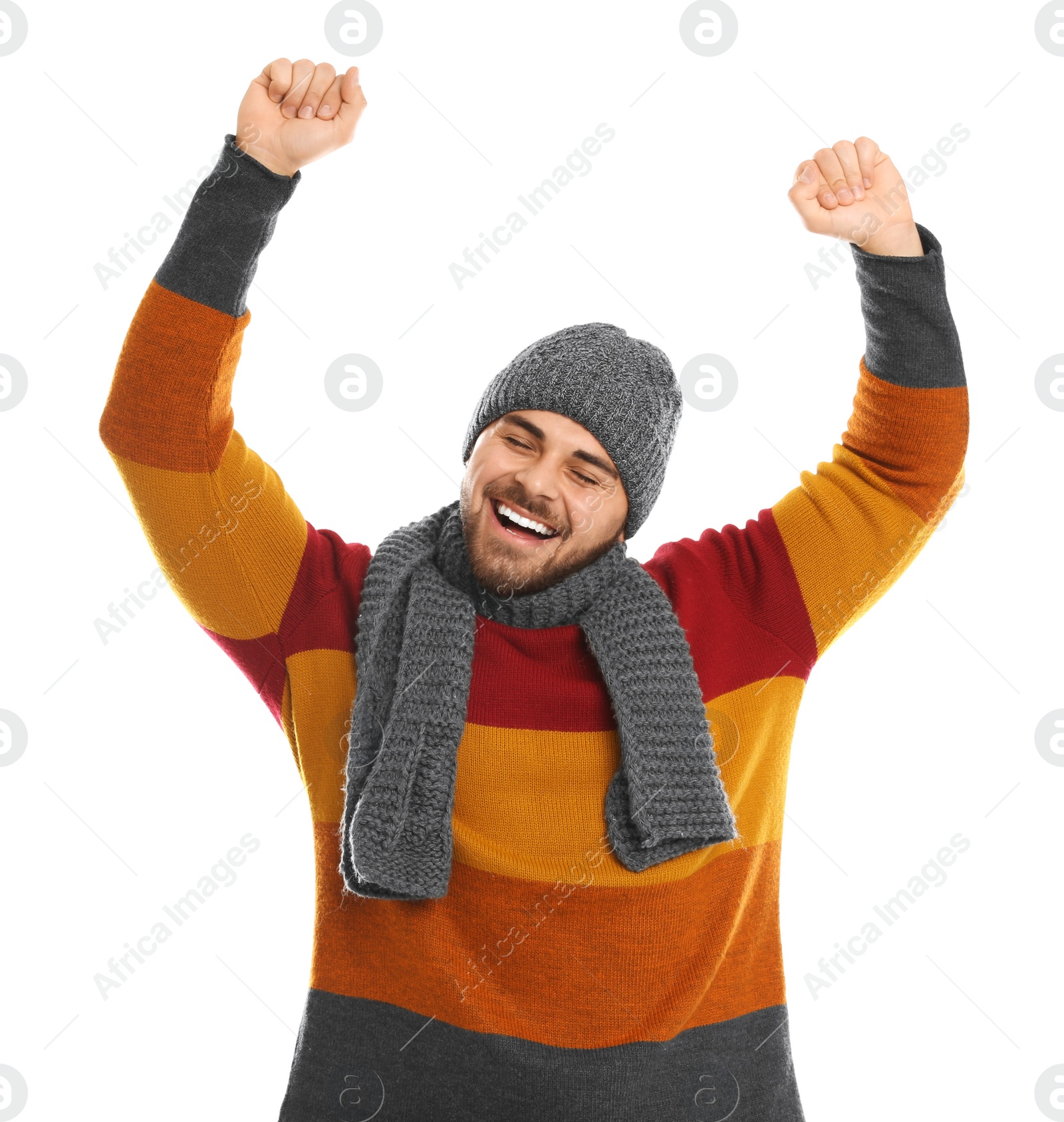 Photo of Emotional young man in warm clothes on white background. Winter vacation