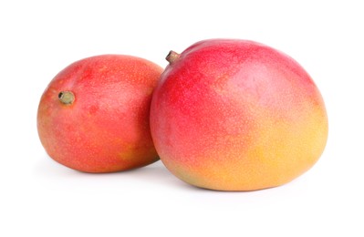 Delicious ripe juicy mangoes on white background