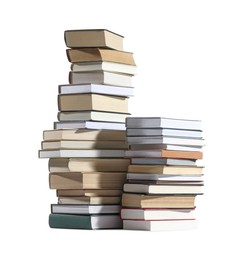 Photo of Stacks of many different books isolated on white