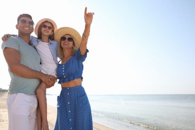 Photo of Happy family at beach on sunny summer day