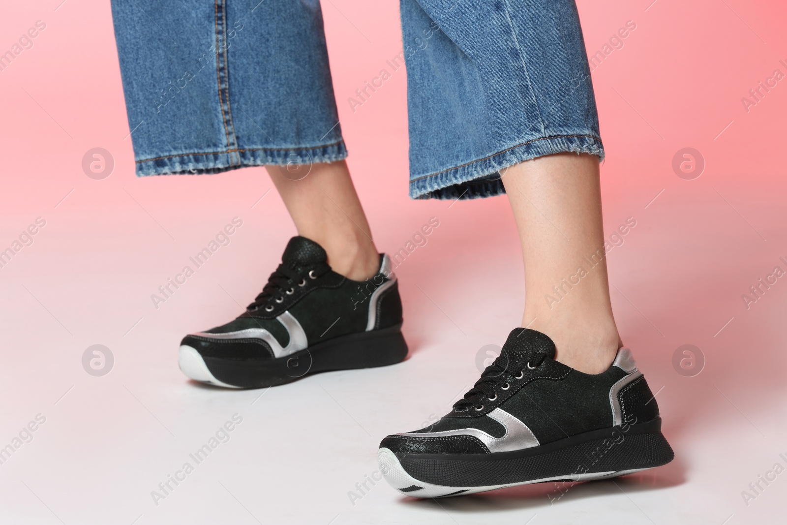 Photo of Woman in stylish shoes on color background, closeup