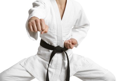 Photo of Martial arts master in keikogi with black belt against white background, focus on fist