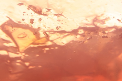 Delicious pink fruit jelly as background, closeup