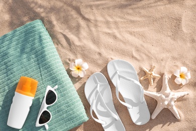 Photo of Flat lay composition with beach accessories on sand