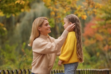Photo of Happy mother with her daughter in autumn park