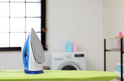 Modern clothes iron on board in laundry room