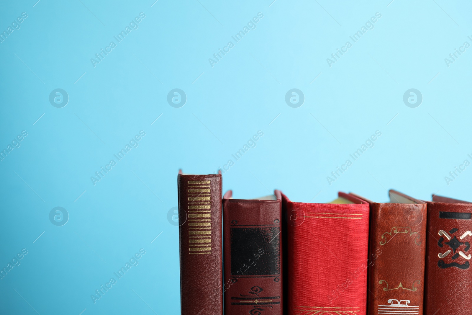 Photo of Collection of old books on light blue background