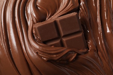 Photo of Tasty milk chocolate paste and pieces as background, top view
