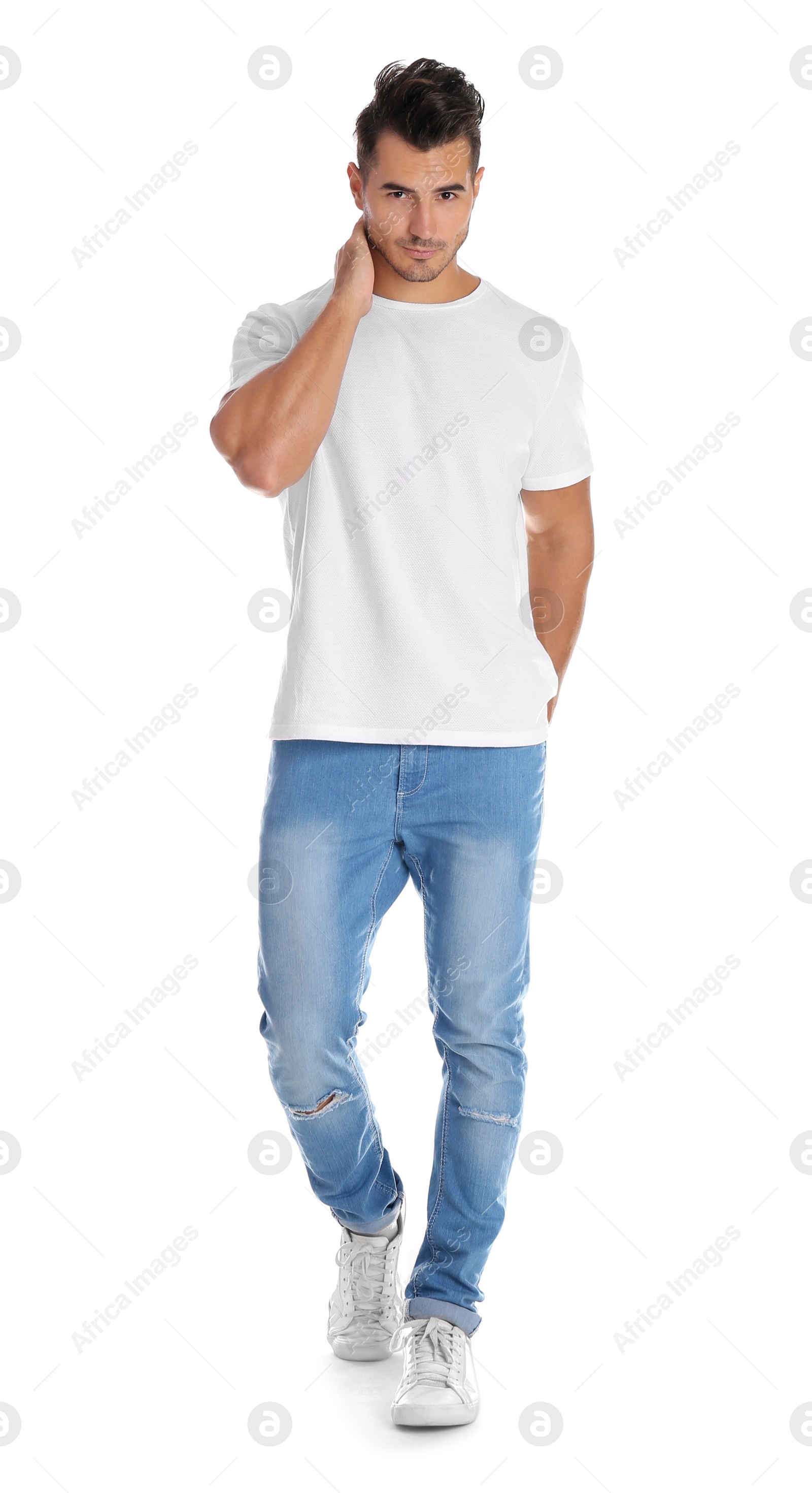 Photo of Young man in stylish jeans on white background