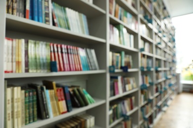 Photo of Blurred view of shelves with books in library