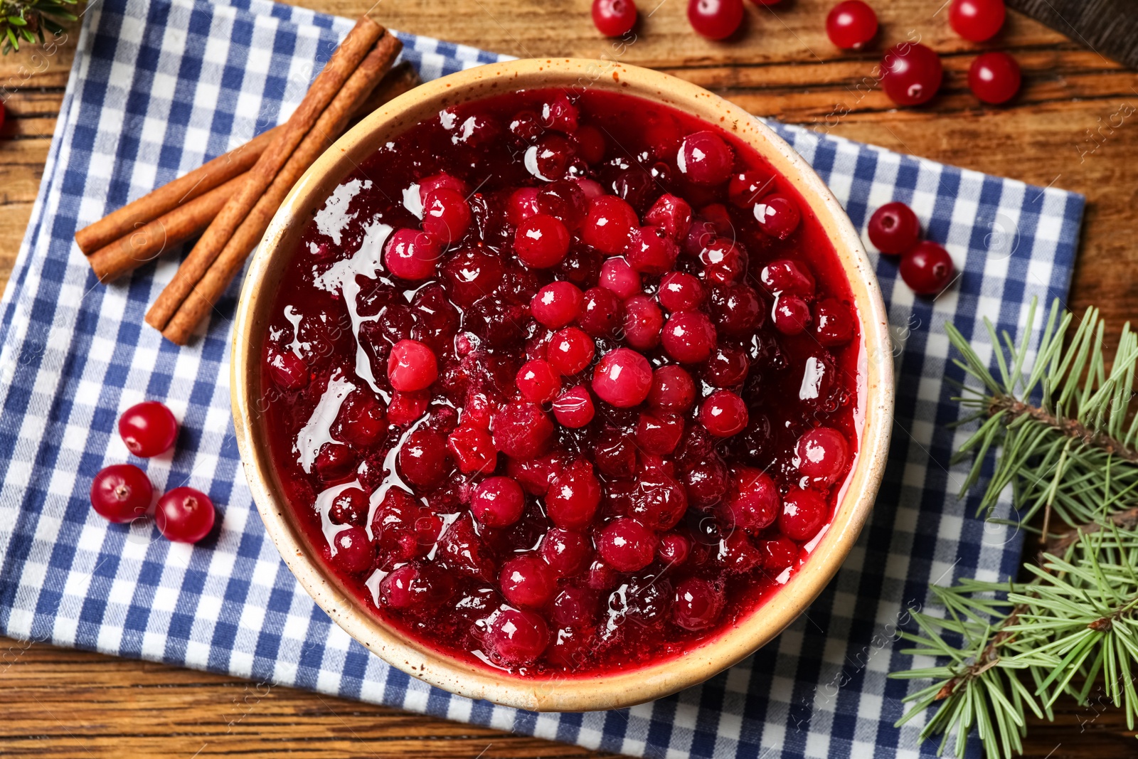 Photo of Flat lay composition with fresh cranberry sauce on table