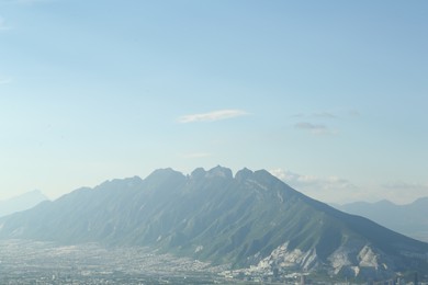 Photo of Big mountains and city under blue sky on sunny day