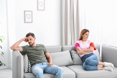 Couple ignoring each other after argument in living room. Relationship problems
