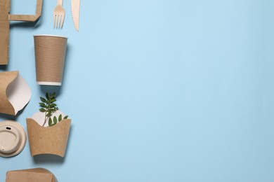 Photo of Flat lay composition with eco friendly food packagings and twigs on light blue background. Space for text