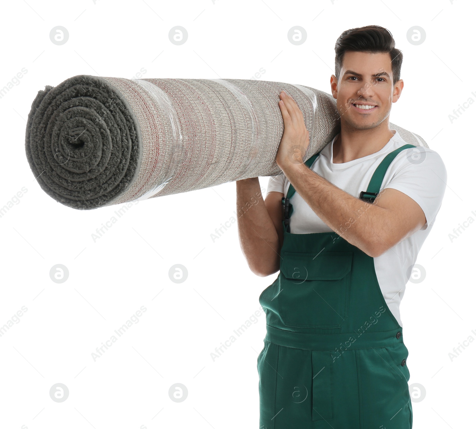 Photo of Male worker with rolled carpet on white background