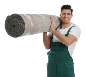 Male worker with rolled carpet on white background