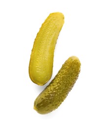 Photo of Tasty cut and whole pickled cucumbers on white background, top view