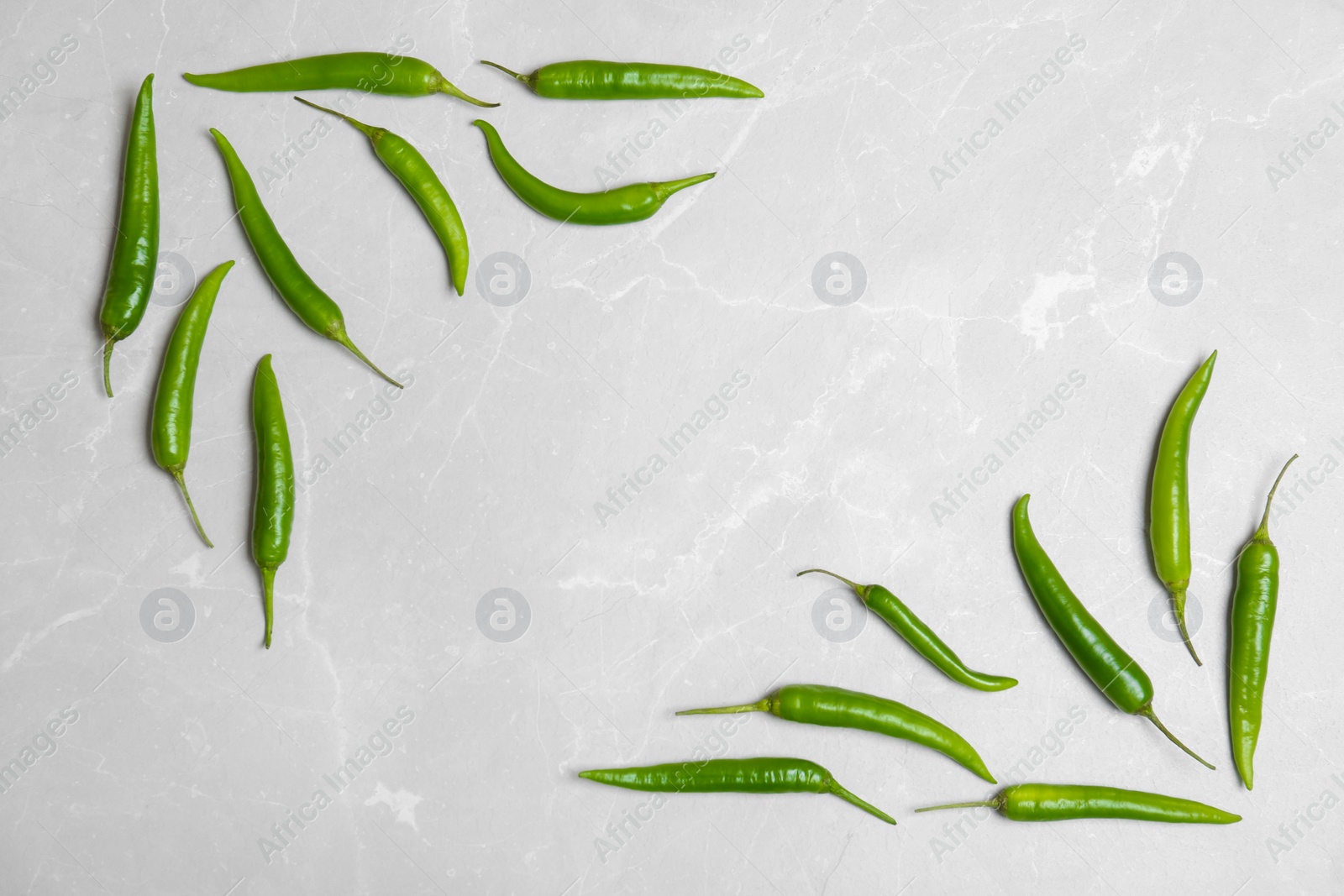 Photo of Flat lay composition with chili peppers on light background