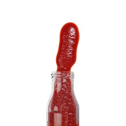 Photo of Ketchup and glass bottle isolated on white, top view