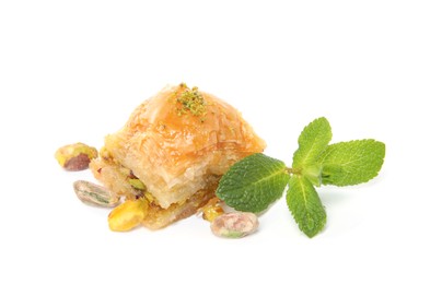 Photo of Delicious baklava with pistachios, mint and scattered nuts on white background