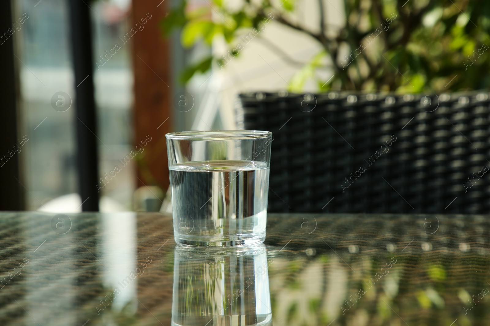 Photo of Glass of fresh water on table, space for text